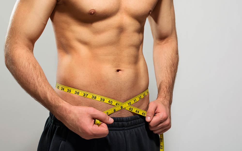 man measuring his waist 