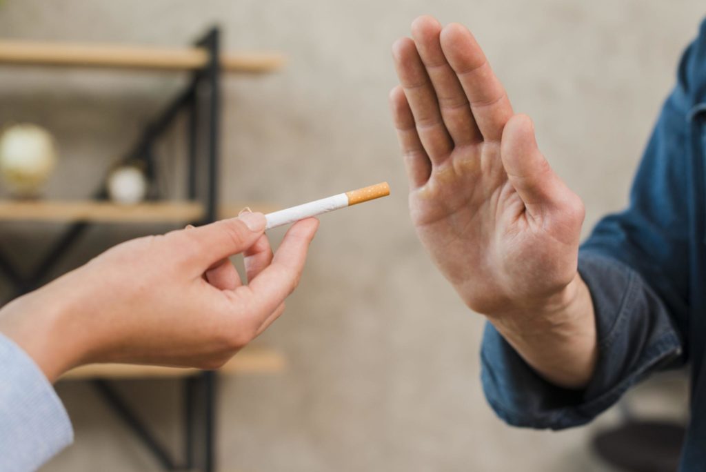 Man refusing cigarettes offered 