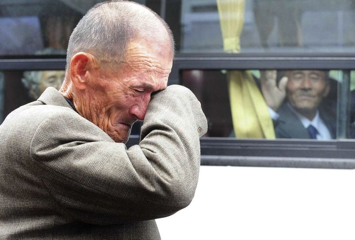 A North Korean waves at his South Korean brother
