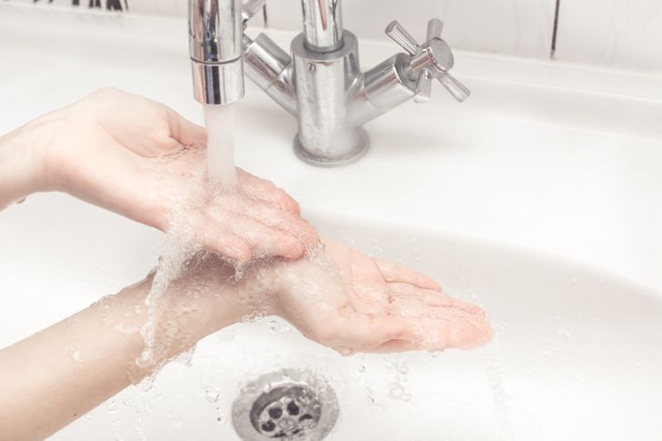 man washing his wrists