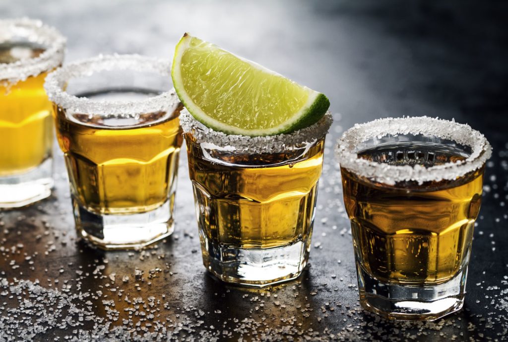 Tasty alcohol drink cocktail tequila with lime and salt on vibrant 