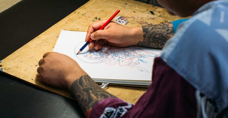 tattoo artist drawing tattoo