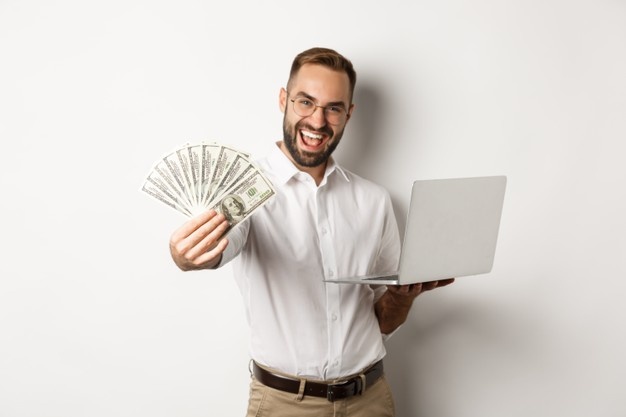 man is holding cash money in one hand