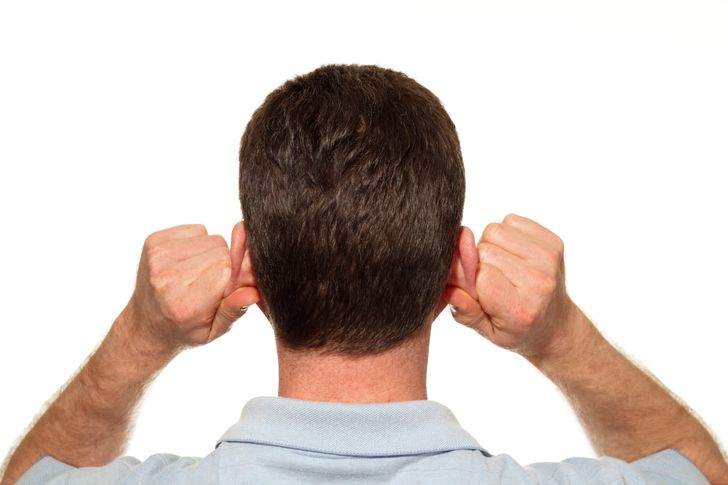 man massage his earlobe