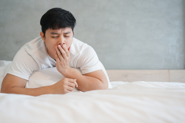 tips to get enough sleep for men, man yawning