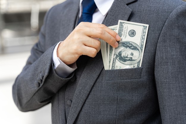 business man holding money us dollar bills in hand