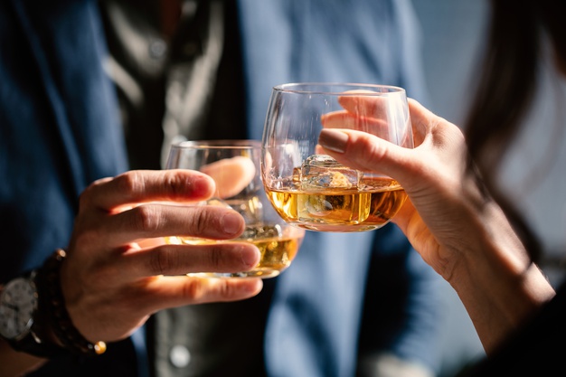 men cheering whisky