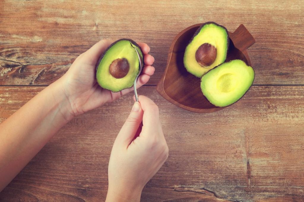 man holding avocado