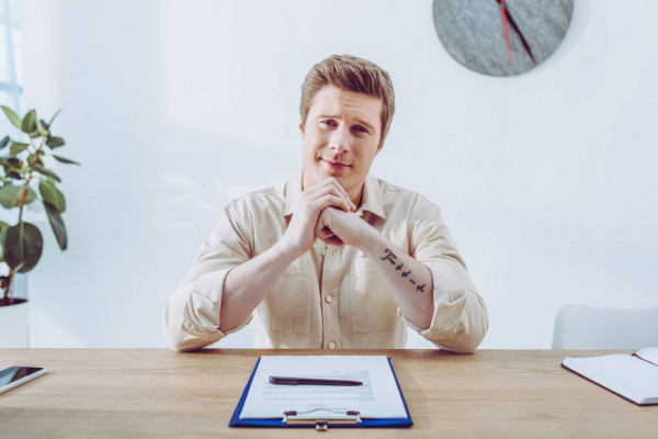 man clenched hands sitting
