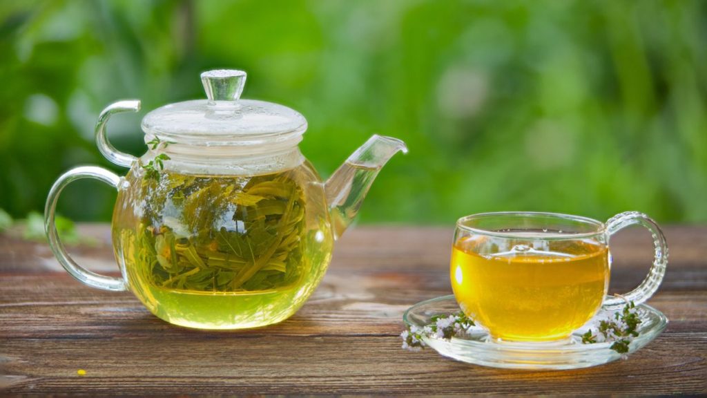 green tea in cup and jar