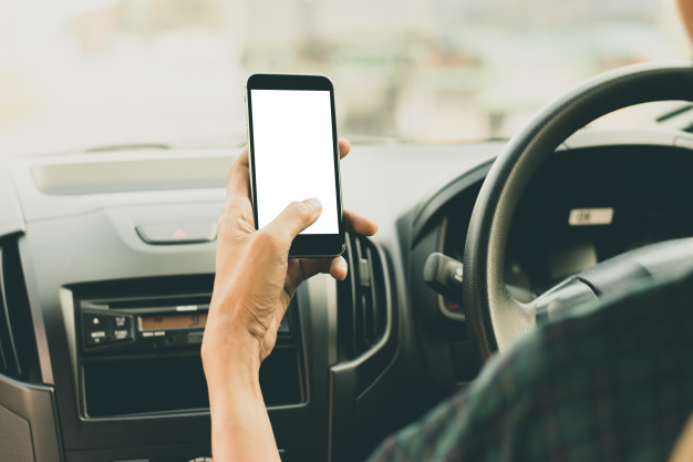 man using phone while driving