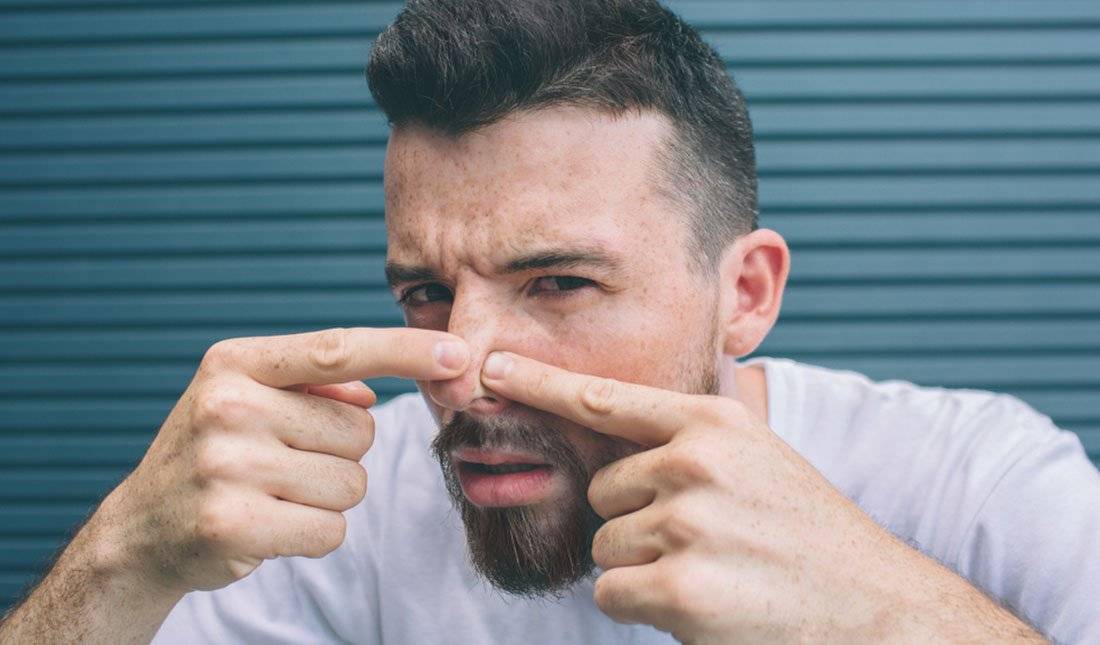 man squeeze out pimple
