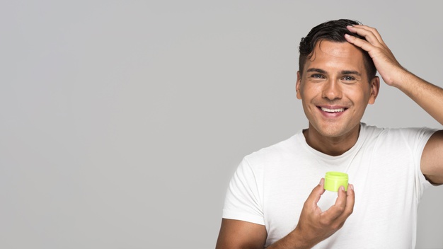man applying hair gel