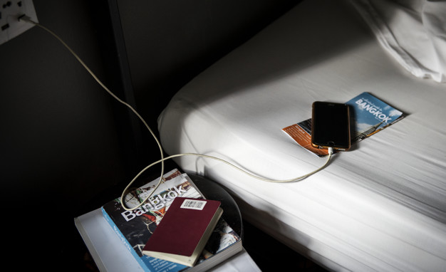 a mobile phone lying on bed 