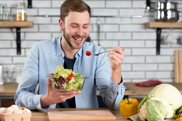 The man eat fork in hand