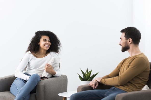 Positive adult man and woman talking
