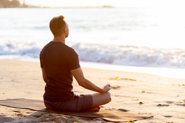 man relaxing on the beach outside
