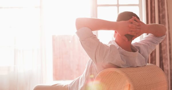 A young man sitting on a sofa thinking
