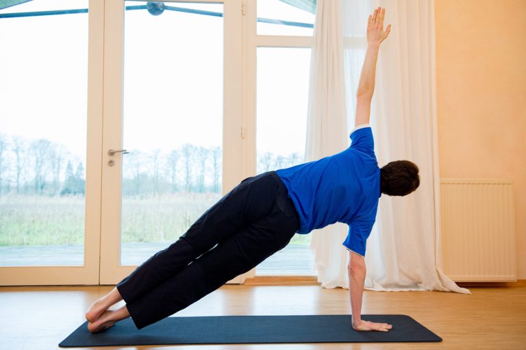 man doing side plank
