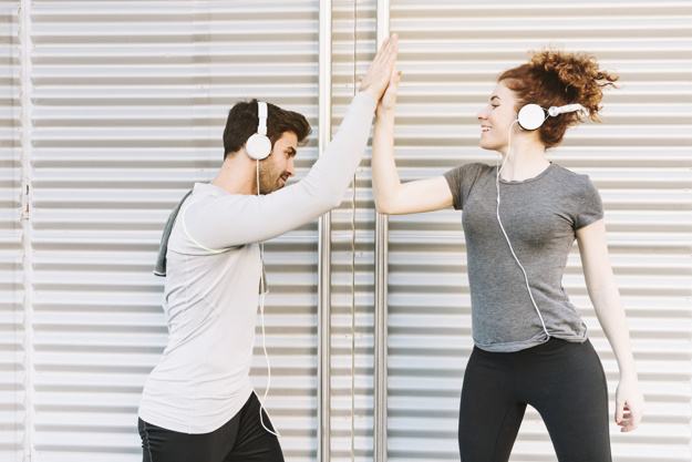 Sporty man and woman giving high five