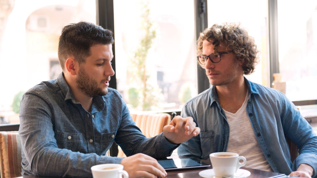Mid-adult man talking with friend