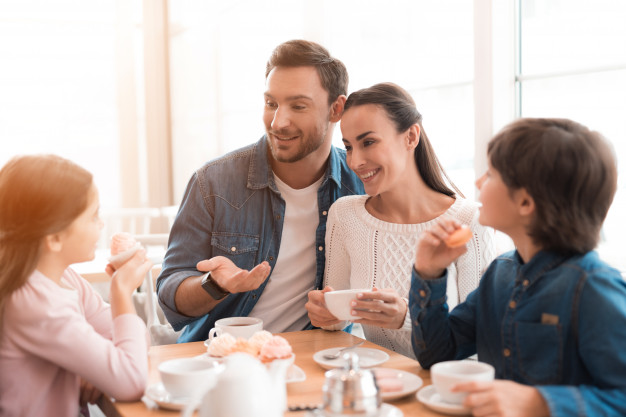 Weekend morning of loving happy family in cafe