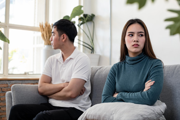angry couple sitting on sofa