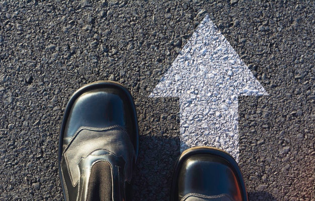 Shoes standing at the crossroad and get to decision which way to go