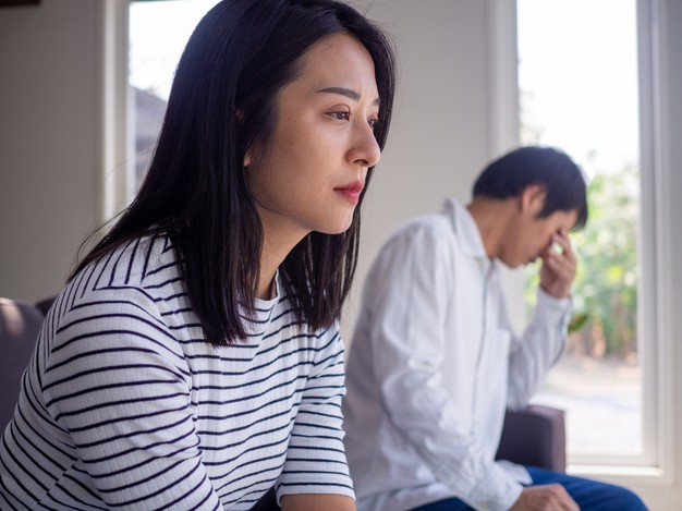 woman is stressed and anxious about the love problems between her husband