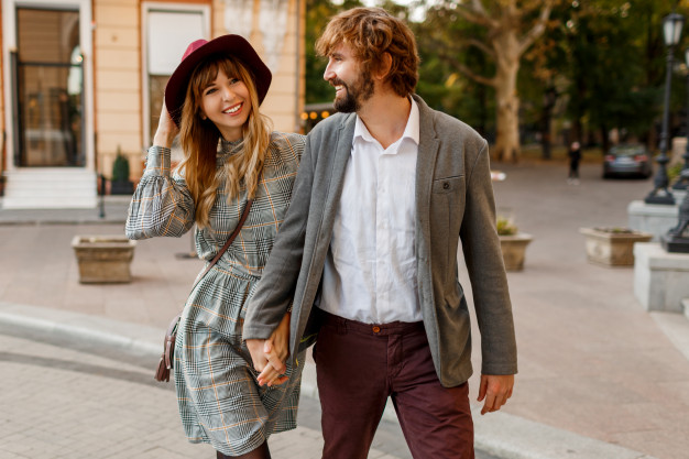 pretty beautiful woman and her handsome stylish boyfriend hugging outdoor