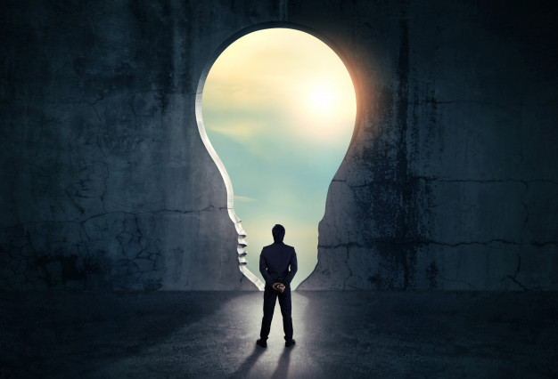 Businessman looking out of abstract opening in wall 