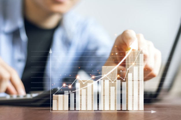 Businessmen are checking stock charts and planning their stock trading strategies for peak growth. 