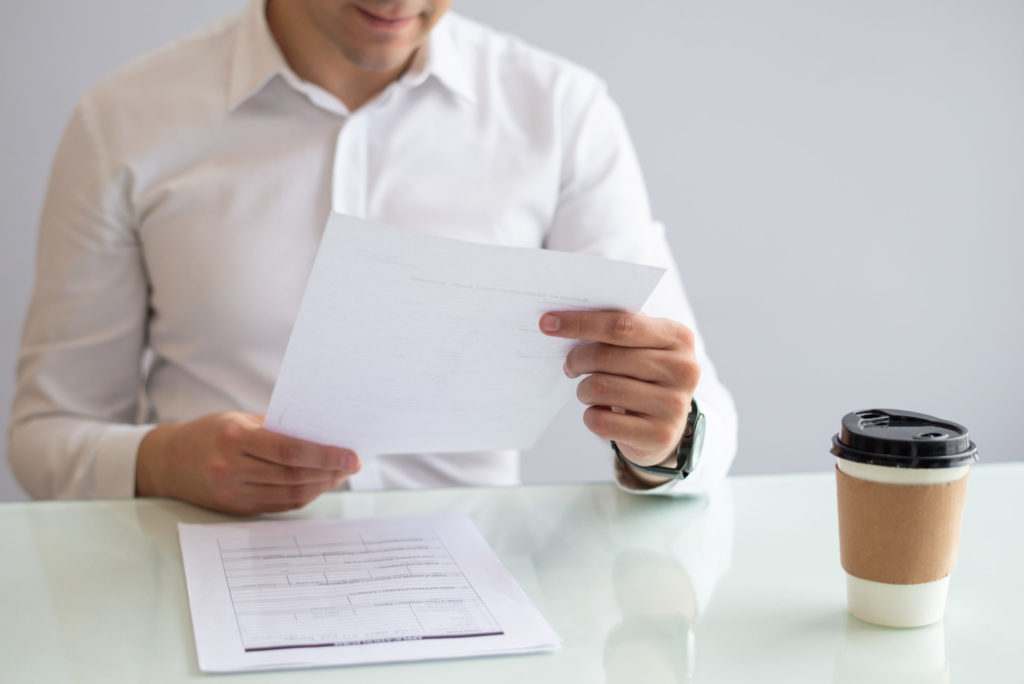 smiling young businessman looking at document