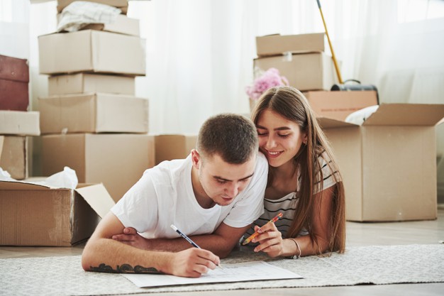cheerful young couple in their new apartment. conception of moving