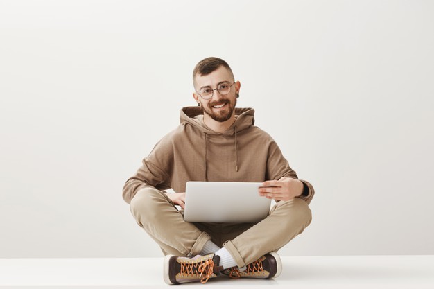 Handsome programmer working with laptop