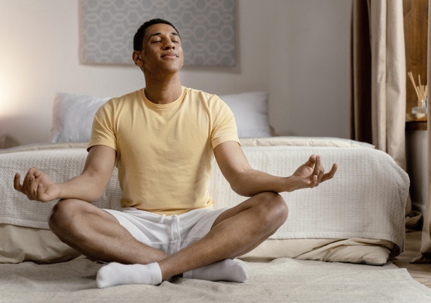 man at home meditating