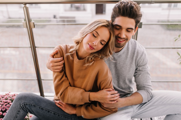  young woman posing with husband at terrace