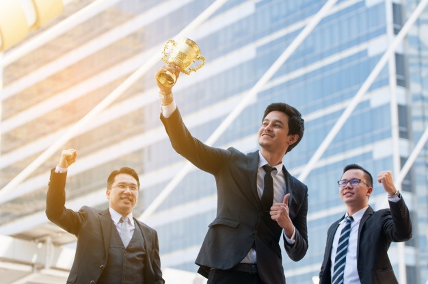 man holding trophy