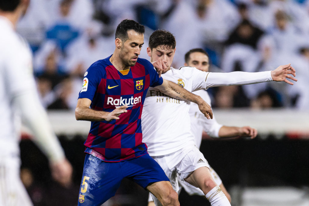 Sergio Busquets of FC Barcelona (L) 