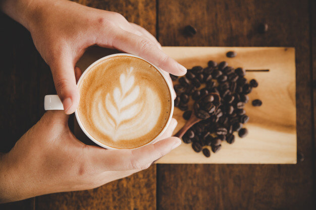 man holding coffee cup; benefits of drinking coffee for men