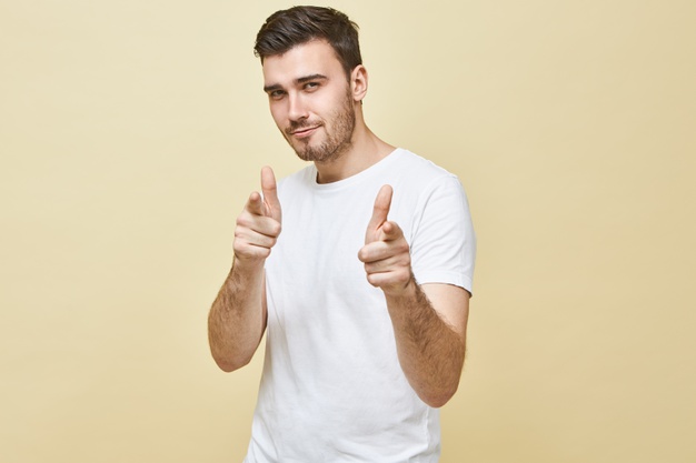 horizontal-shot-handsome-charismatic-young-man-with-black-hair-stubble-posing-isolated-pointing-fore-fingers-having-confident-flirty-facial-expression-choosing-you-body-language