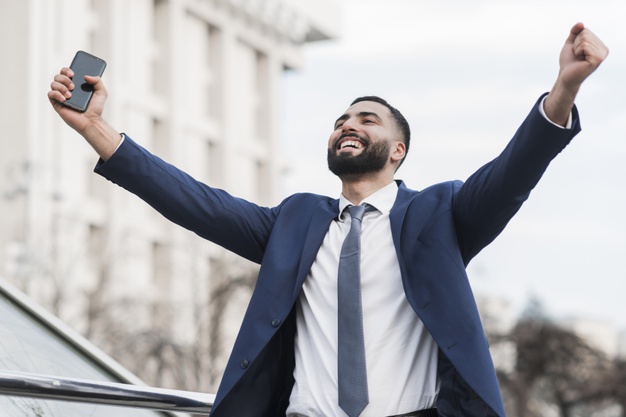 Low angle business man happy