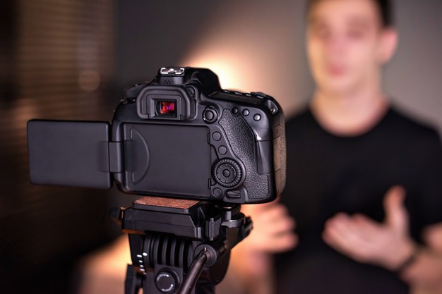 man-talking-camera-recording-himself-vlog-working-from-home-young-content-creator