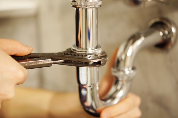 man fixing pipe