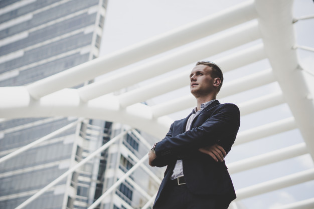 portrait-happy-businessman-standing-front-business-center