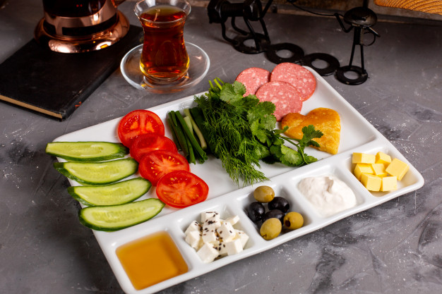 side-view-traditional-turkish-breakfast-with-olives-feta-cheese-honey-vegetables-tea