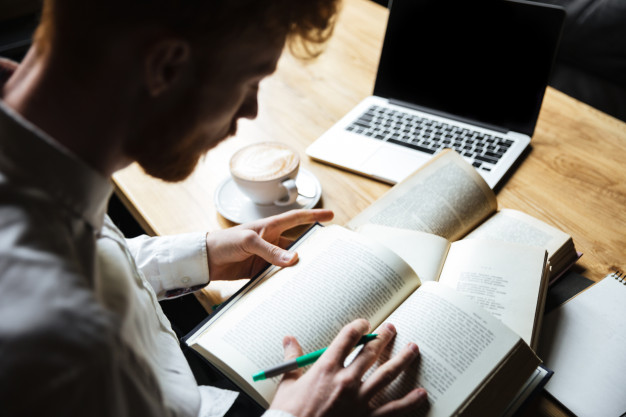 young redhead male student preparing for university exam 