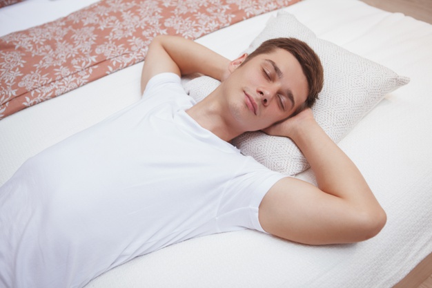 Young man sleeping on the bed