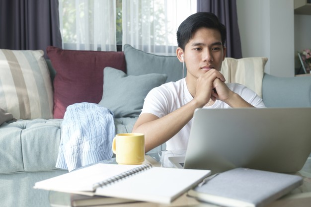 man working and learning online at home. young man video call conference online with his colleagues