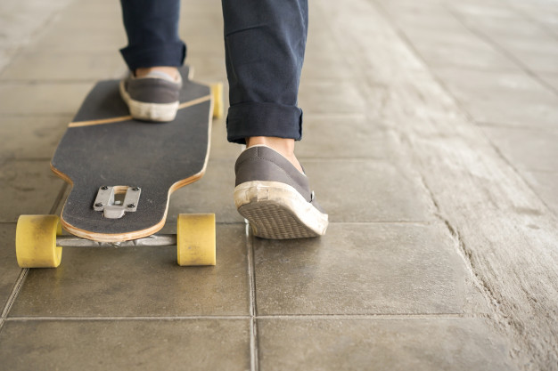 young-teenager-boy-playing-skateboard-public-park